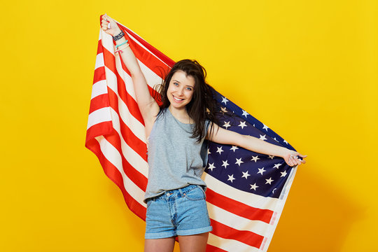 Cheerful Teenage Patriotic Girl With US Flag