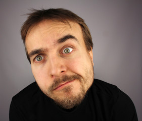 Fototapeta premium portrait of confused man, on a gray background