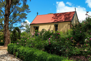 Fototapeta na wymiar Old church in cottage garden