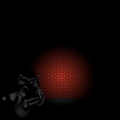 Rear view of v-twin motorcycle front light on a red brick wall in the night