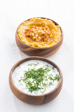 yoghurt sauce and hummus in bowls, vertical