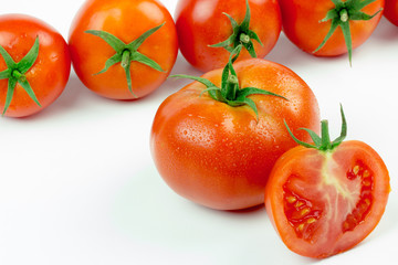 Tomatoes. Whole and a half isolated on white