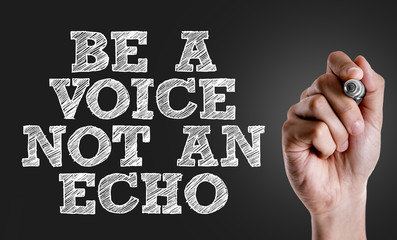 Hand writing the text: Be a Voice Not An Echo
