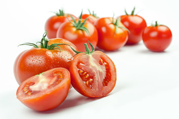 Tomatoes. Whole and a half isolated on white