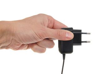 The electric adapter in a hand, isolated on the white
