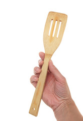 Wooden spoon in a hand, isolated on the white