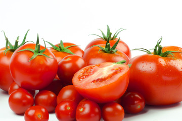 Tomatoes. Whole and a half isolated on white