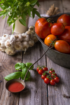Still life of homemade tomato sauce with tomatoes, garlic and herbs