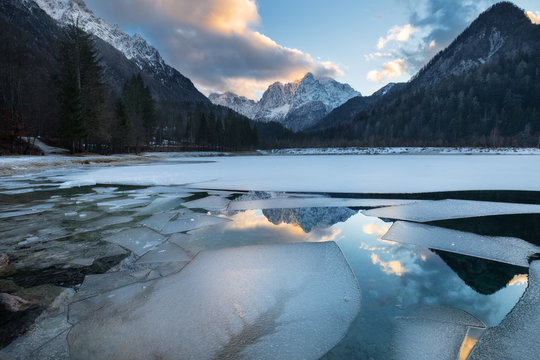 Frozen Sava Dolinka River bordered by snowy mountains in winter, Kranjska Gora, Upper Sava Valley, Slovenia