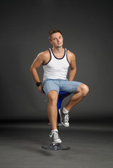 Obraz premium Portrait of a relaxed man sitting on a bar stool