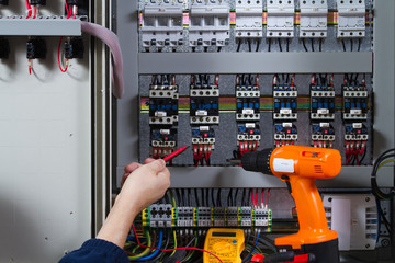 electrician at work with an electric panel
