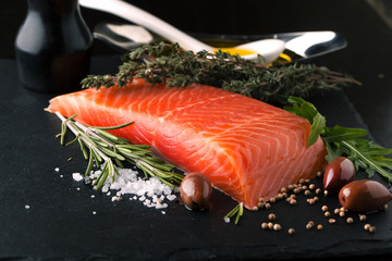 Fresh salmon with spices, herbs, rosemary and olive oil