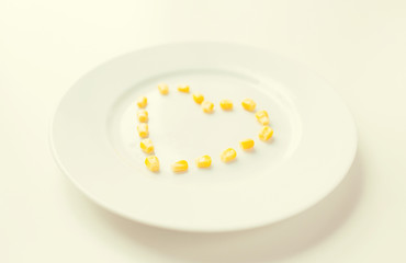 close up of plate with corn in heart shape 