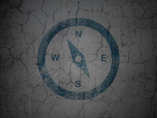 Tourism concept: Compass on grunge wall background