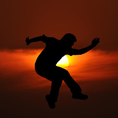 Middle aged man silhouette actions with sun set background.