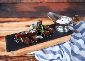 Fragrant toasts from black bread with cheese parmesan and white