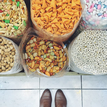 Feet standing in front of snacks in a market