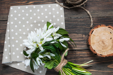 snowdrops bunch on wooden background. Close up