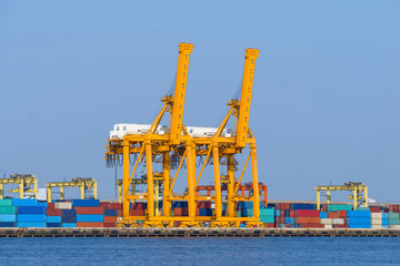 Cargo ship loading containers in harbor