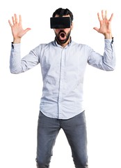 Man using VR glasses doing surprise gesture