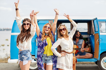 happy hippie friends having fun over minivan car - obrazy, fototapety, plakaty