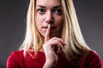 Naklejka premium woman with finger on her lips
