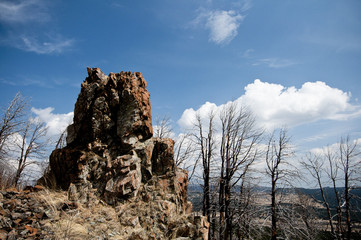 panoramic views of lone rock amongst white clouds