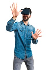 Man using VR glasses touching on transparent screen