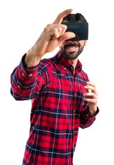 Man using VR glasses holding something