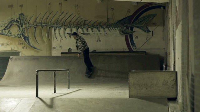 Young man does a trick on a skateboard on the rails