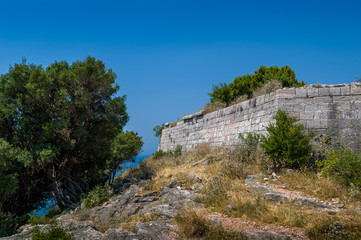 Fototapeta premium Stone walls of ancient fortress up the hill