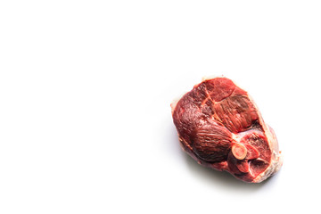beautiful raw slice of an organic leg of lamb meat on a white background seen from above