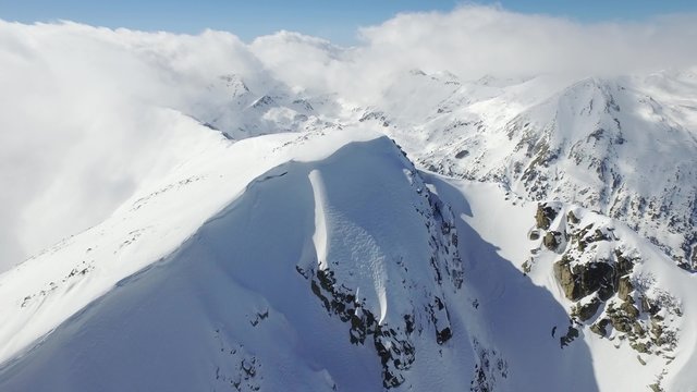 Beautiful Mountain Range Winter Landscape Clouds Aerial Flight Footage Over Peaks Epic Panorama  UHD 4K