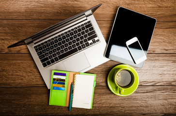 Office desk with laptop computer, tablet pc, planner, pen, mobil