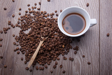 white cup and coffee on wooden background