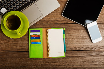 Office desk with laptop computer, tablet pc, planner, pen, mobil