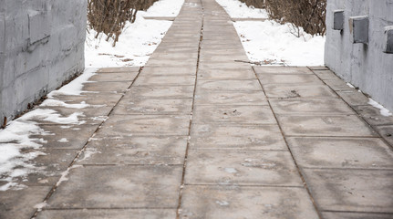 footprints on snowy sidewalk, first snow of the year
