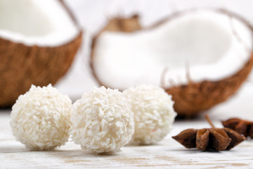 Candies and fresh coconut on white background