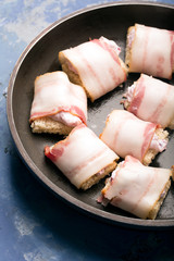 Rich snack of bacon and bread stuffed with cheese