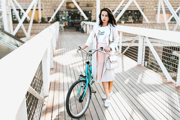 Beautiful young girl with bicycle  - 105355863