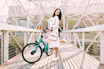 Beautiful young girl having fun with bicycle - 105355874