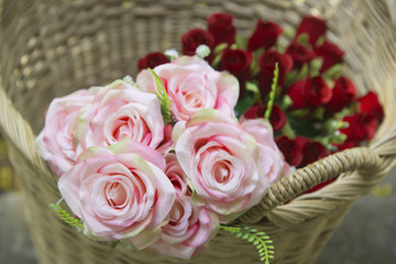 Many fake pink roses in a basket