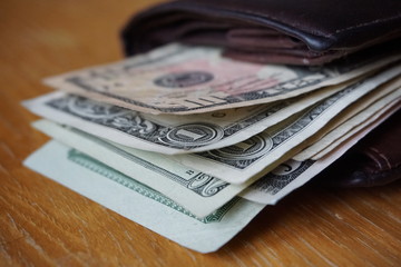 
Detail of the American money (USD, US, US dollars), bank notes inserted in the leather wallet