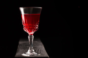 Glass of red wine on a wooden table