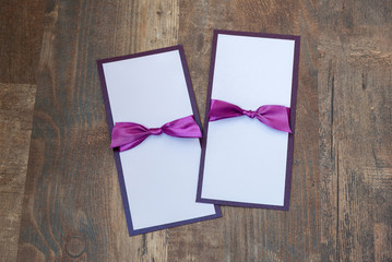 handmade cards with purple satin tape on wood background