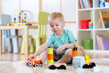 kid boy toddler playing car toys at home