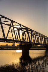 夕暮れ時の鉄橋と電車