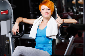 Attractive fit girl with red short hair in gym