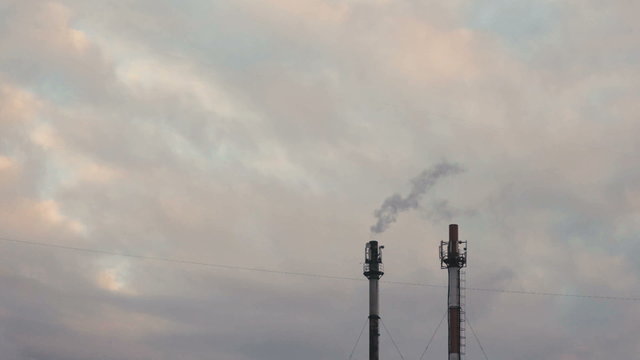 industrial smoke from chimney on grey sky