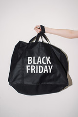 Bag black with white lettering in the hands of Black Friday